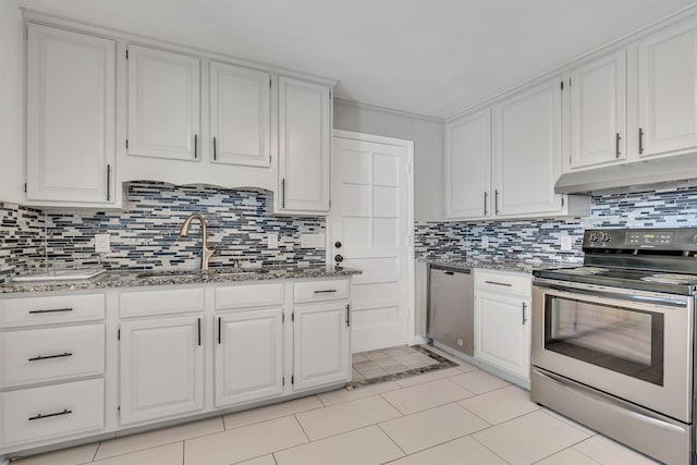 kitchen with stone counters, sink, light tile patterned flooring, stainless steel appliances, and white cabinets