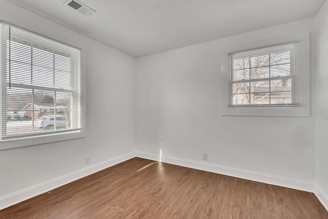 spare room with wood-type flooring