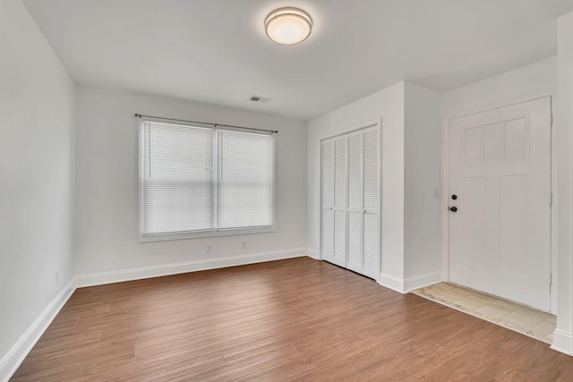 interior space with a closet and hardwood / wood-style flooring