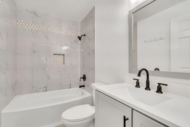 full bathroom featuring toilet, tiled shower / bath combo, and vanity