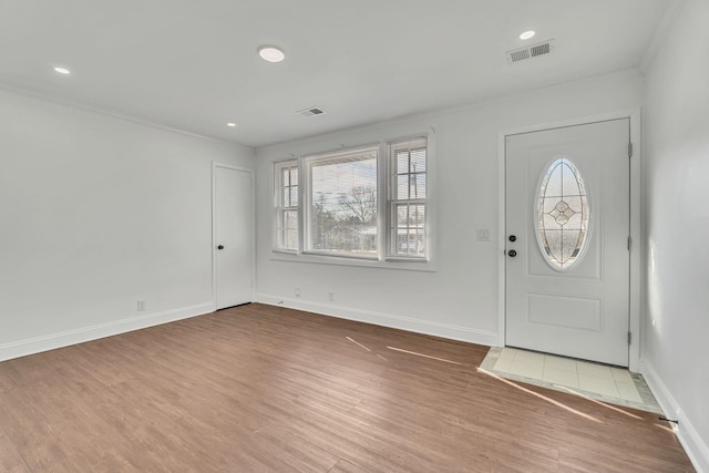 entrance foyer with wood-type flooring and ornamental molding