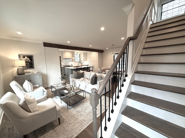 living room featuring crown molding and hardwood / wood-style flooring