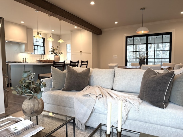 living room featuring crown molding and beamed ceiling