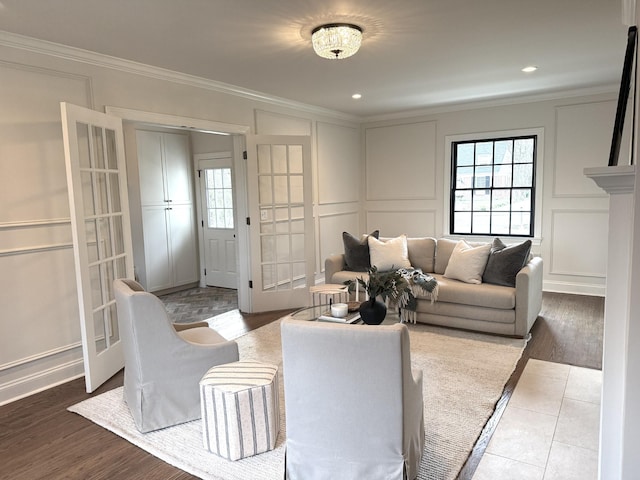 living room with crown molding, hardwood / wood-style floors, and a wealth of natural light