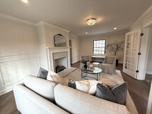 living room featuring ornamental molding, dark wood-type flooring, and a high end fireplace