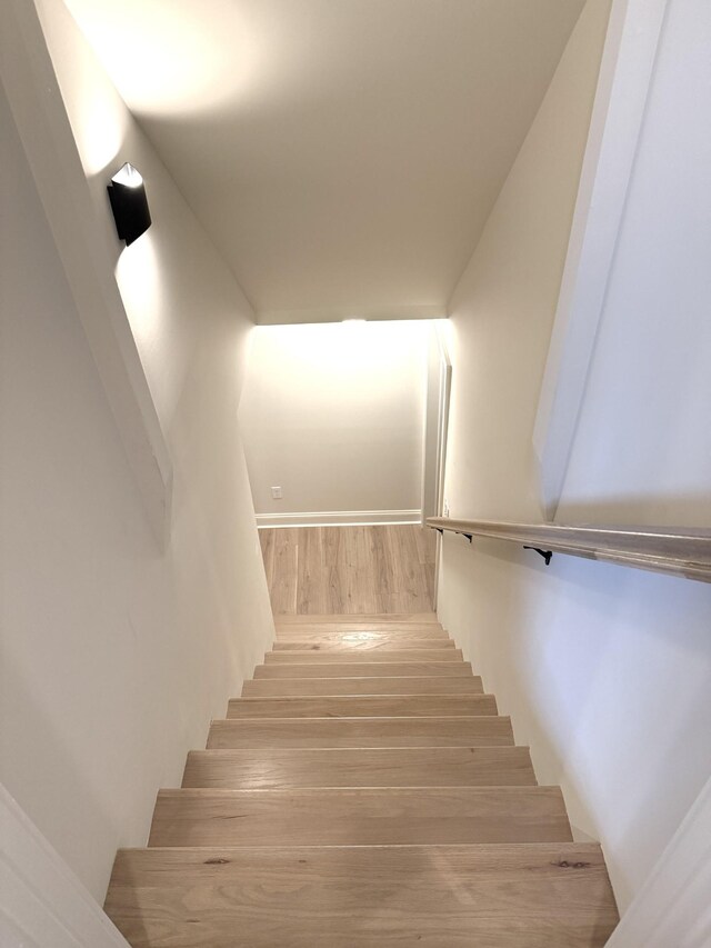 stairway with hardwood / wood-style floors