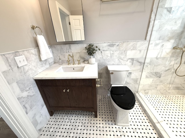 bathroom with tile walls, vanity, tile patterned floors, toilet, and walk in shower