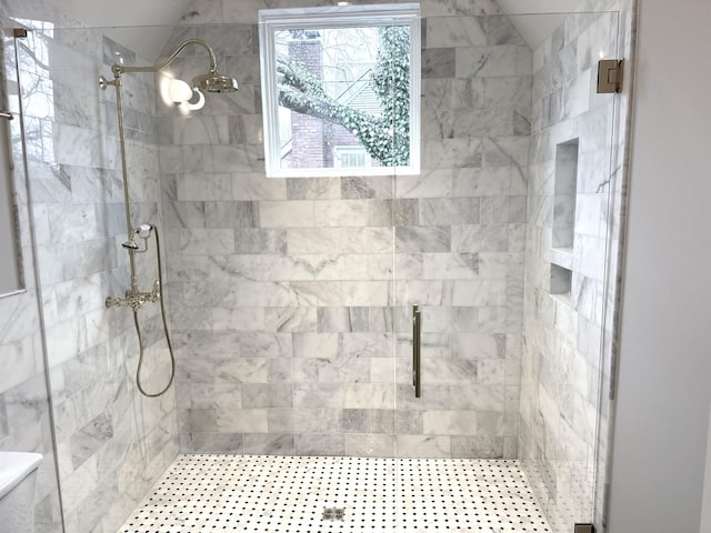 bathroom featuring a shower with shower door