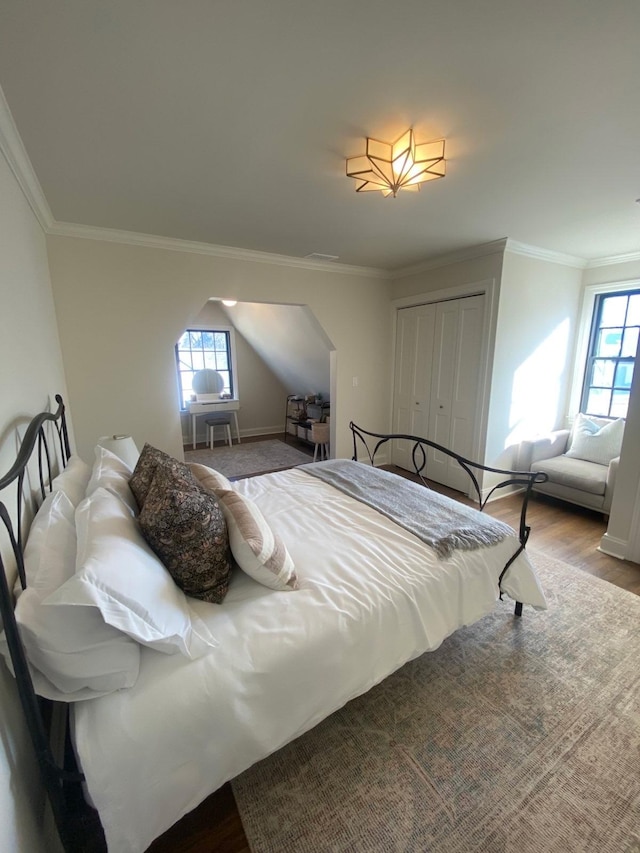 bedroom featuring crown molding, hardwood / wood-style floors, and a closet