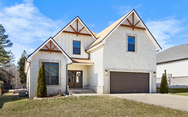 view of front of property featuring a garage, a front lawn, and central air condition unit