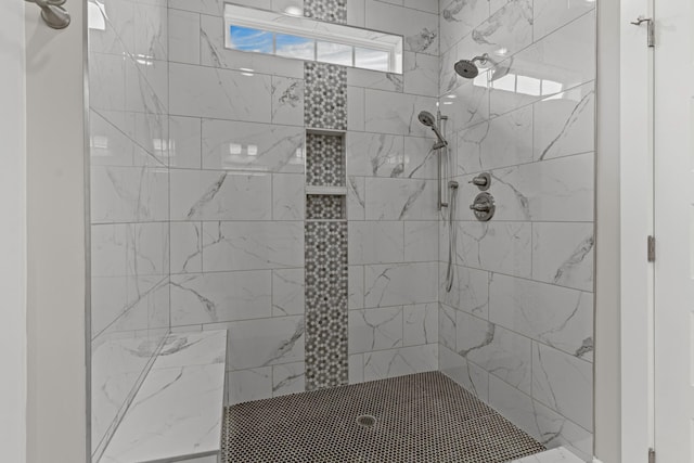 bathroom featuring a tile shower