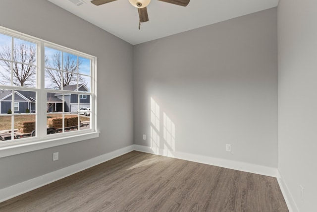 spare room featuring hardwood / wood-style flooring and ceiling fan