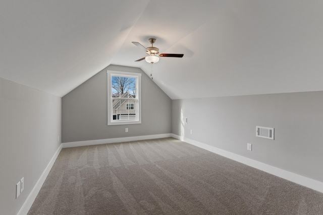 additional living space featuring ceiling fan, vaulted ceiling, and carpet