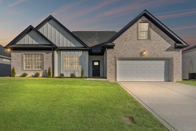 view of front of house featuring a garage and a yard