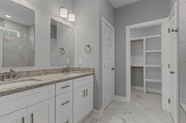 bathroom featuring vanity and tiled shower