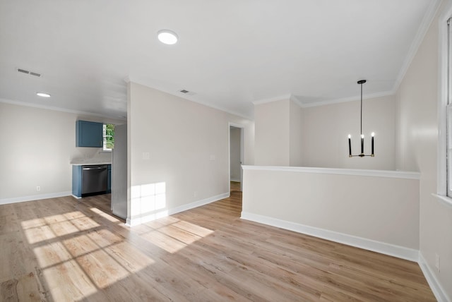 unfurnished room with ornamental molding, light hardwood / wood-style floors, and an inviting chandelier