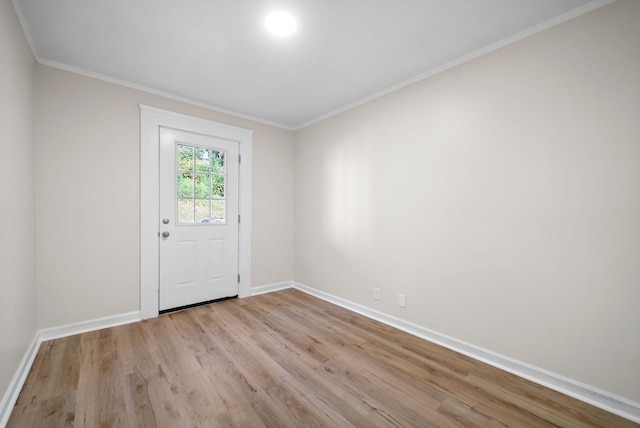 unfurnished room featuring light wood-type flooring and ornamental molding