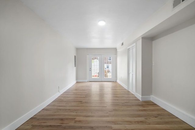 interior space featuring french doors and light hardwood / wood-style flooring