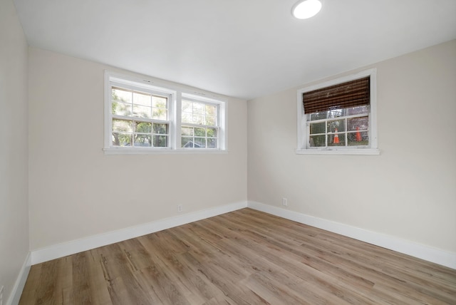 unfurnished room with light wood-type flooring