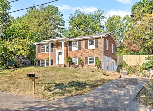 raised ranch with a garage and a front lawn