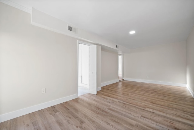 spare room with light hardwood / wood-style flooring