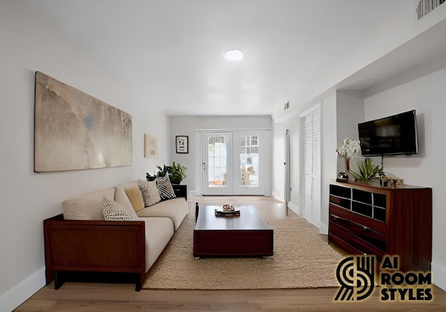 living room featuring baseboards, visible vents, wood finished floors, and french doors