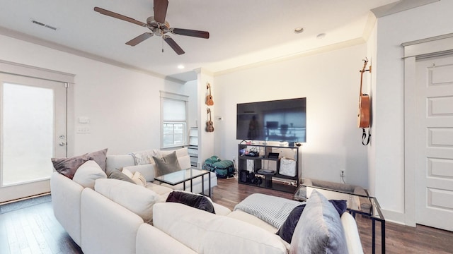 living room featuring ornamental molding, ceiling fan, and dark hardwood / wood-style floors