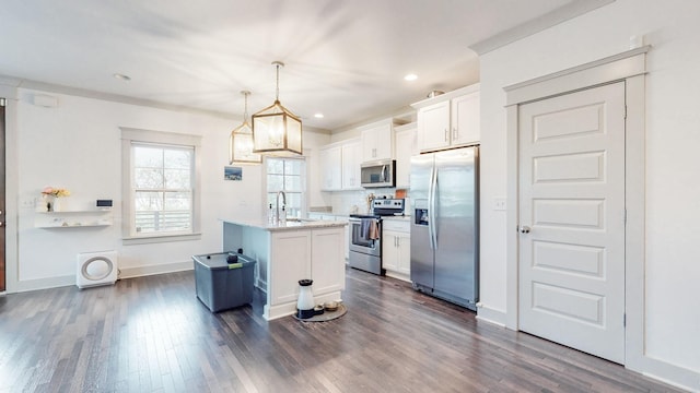 kitchen with stainless steel appliances, white cabinetry, a center island, hanging light fixtures, and dark hardwood / wood-style floors