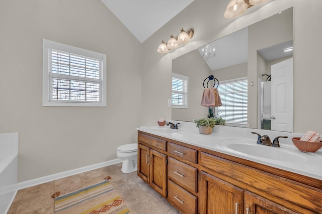 bathroom with lofted ceiling, vanity, toilet, and a bathing tub