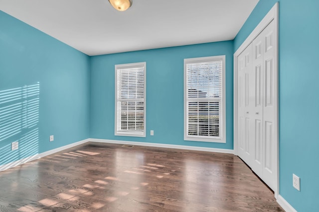 unfurnished room featuring dark hardwood / wood-style flooring