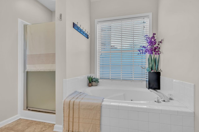 bathroom featuring shower with separate bathtub