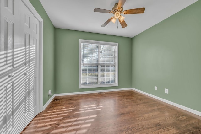 spare room with hardwood / wood-style floors and ceiling fan