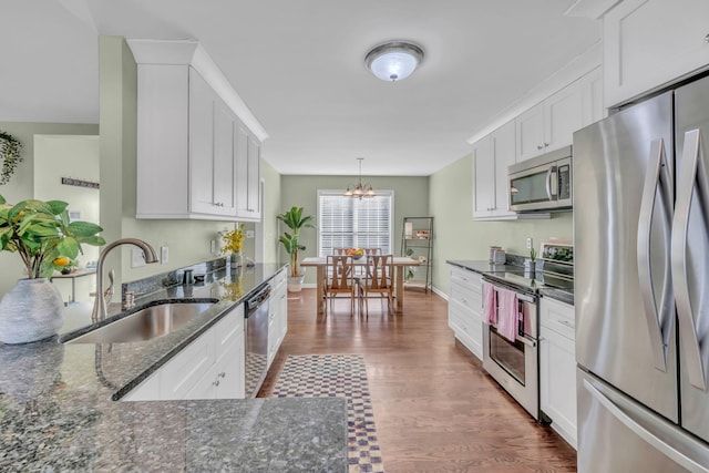 kitchen with sink, stainless steel appliances, and white cabinets