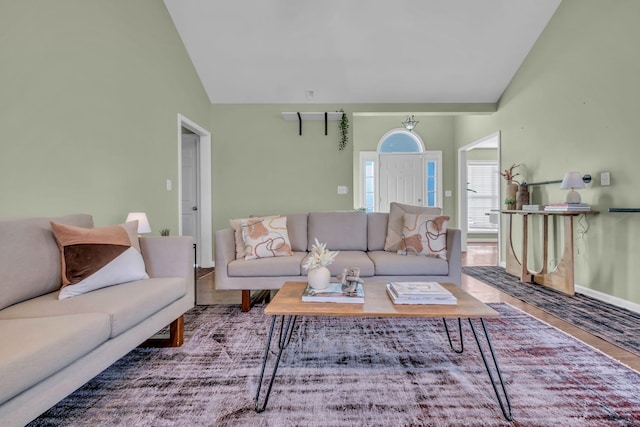 living room with high vaulted ceiling and hardwood / wood-style floors