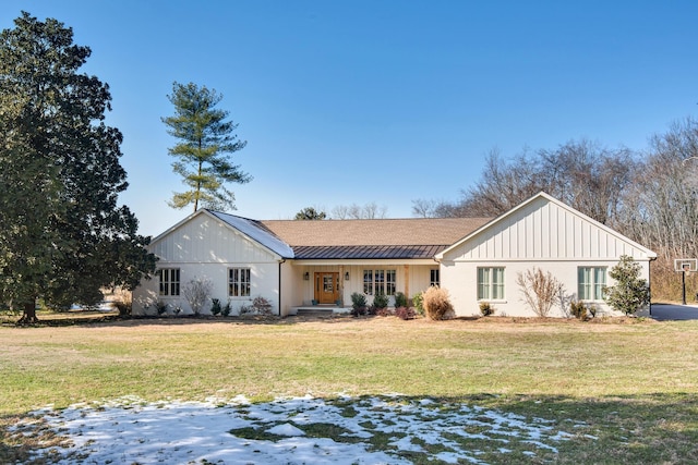 rear view of property with a yard