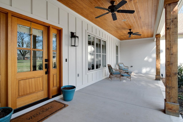 view of exterior entry with covered porch and ceiling fan