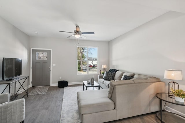 living room featuring ceiling fan and hardwood / wood-style flooring