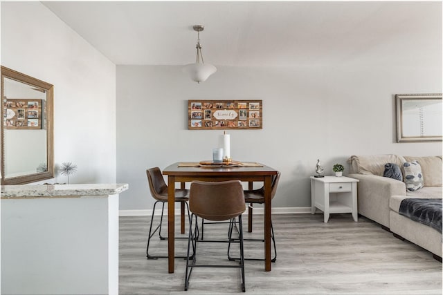 dining space with light hardwood / wood-style flooring