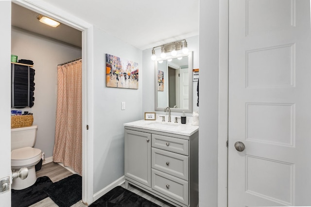 bathroom featuring toilet and vanity