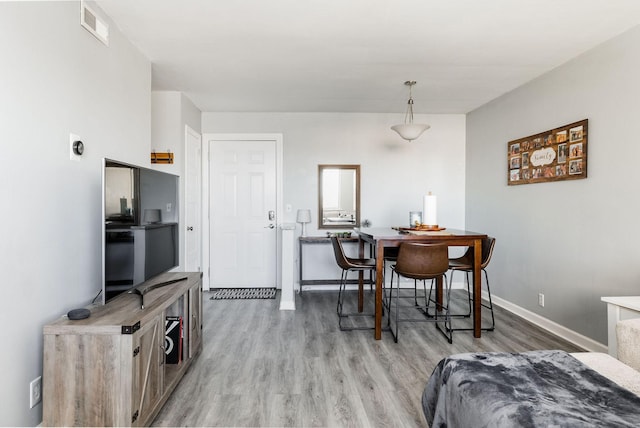 dining space with hardwood / wood-style flooring