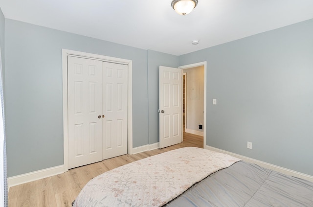 bedroom featuring light wood-type flooring and a closet