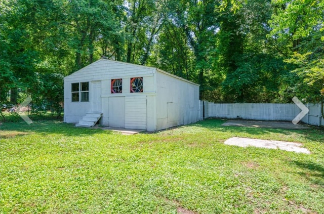 view of outbuilding featuring a lawn