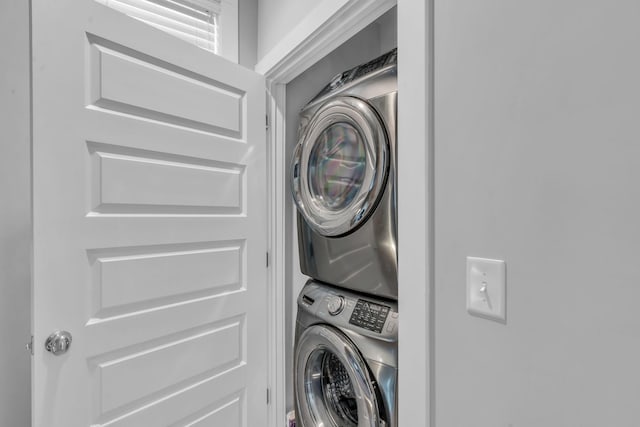 washroom featuring stacked washer and dryer