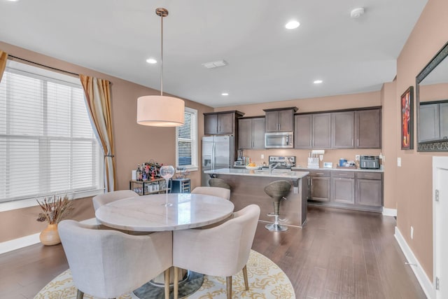 dining space with dark wood-type flooring