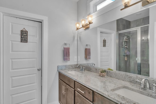 bathroom featuring a shower with door, vanity, and a notable chandelier