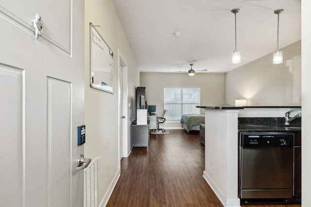 kitchen featuring dishwasher, hanging light fixtures, ceiling fan, dark wood-type flooring, and sink