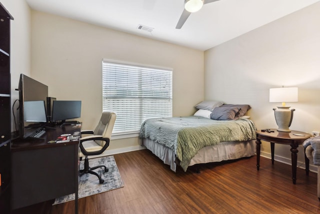 bedroom with ceiling fan, wood finished floors, visible vents, and baseboards