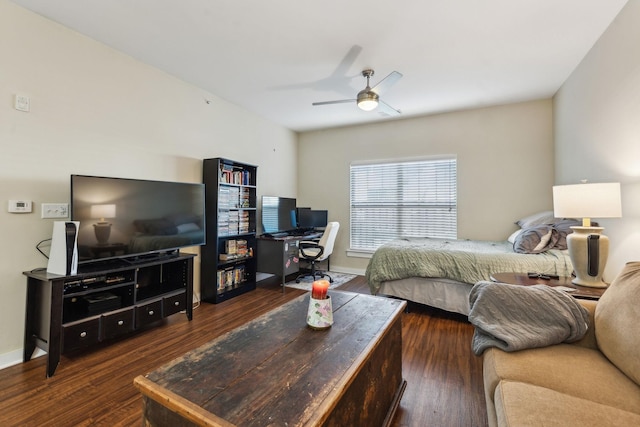 bedroom with dark wood-style flooring, a ceiling fan, and baseboards