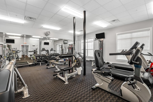 exercise room featuring a paneled ceiling, carpet, and visible vents