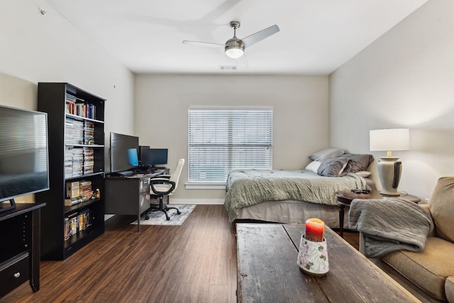 bedroom featuring visible vents, ceiling fan, baseboards, and wood finished floors